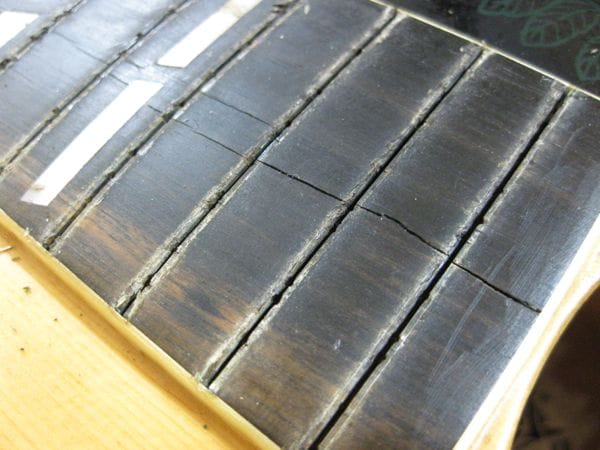 Acoustic guitar fretboard cracks