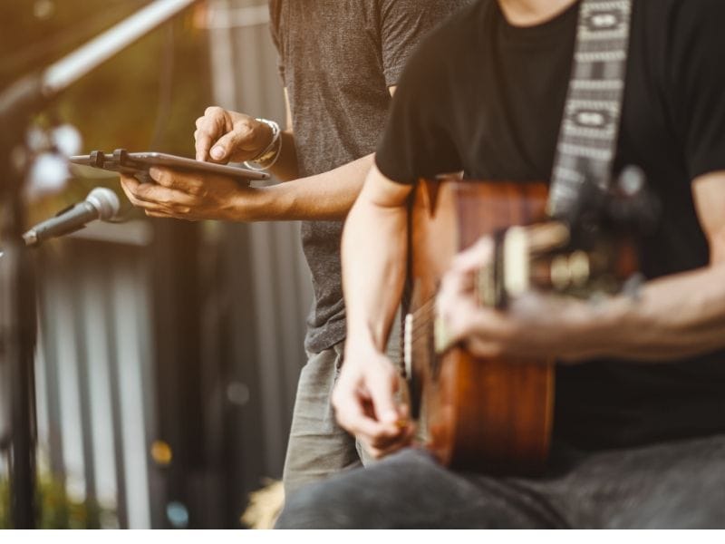 Musicians on stage with tablet