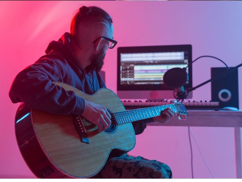 Guitar player in home studio