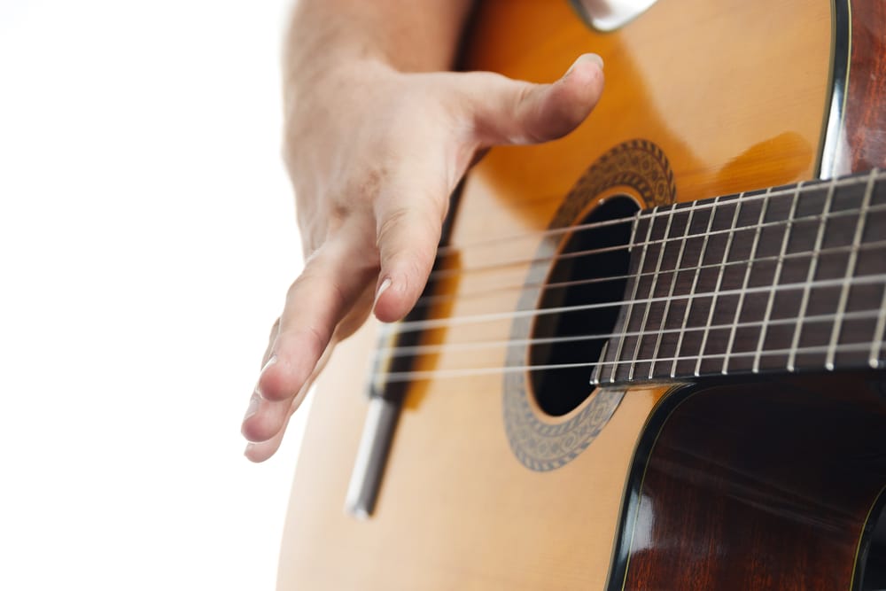 Rasgueado technique demonstration at the end of the strum.